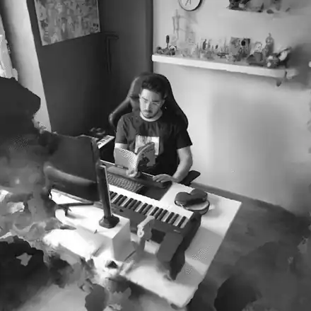 Hussen Othman at his desk, reading